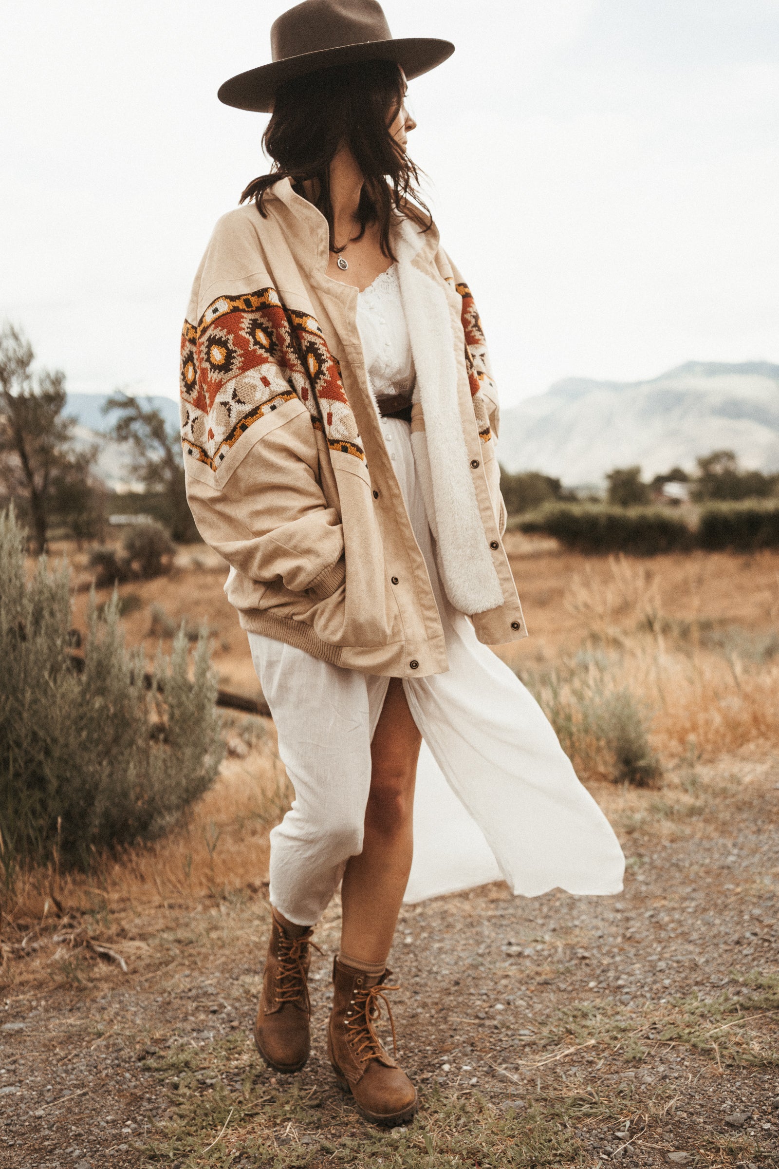 Woman wearing The Cream Rarebird Bomber Navajo Jacket from OTTWAY The Label, showcasing sustainable and eco-friendly fashion